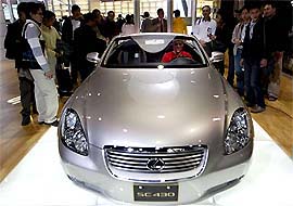 Visitors view a new Lexus SC-430 at the 2004 International Auto Show in Taipei on Saturday