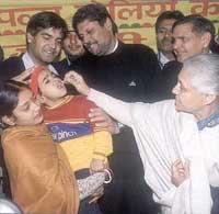 Chief Minister Sheila Dikshit administers polio drops to a child during the formal launch of the drive at her residence