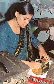 Jaspreet working on a plaque of the Golden Temple