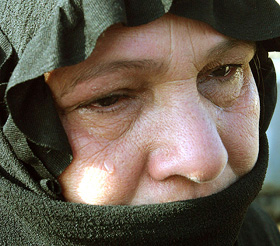 An Iraqi woman cries while recounting on Saturday how the US forces on previous night targeted her farm