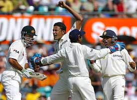 Anil Kumble celebrates with team-mates Parthiv Patel and Akash Chopra after dismissing Australias Ricky Ponting 
