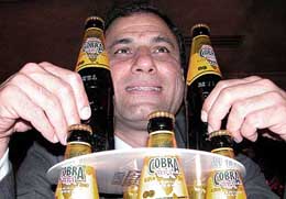 Co-chairman of Indo-British Partnership, Mr Karan F Bilimoria, shows 'Cobra Nag' beer, a popular brand in UK, during its launch in New Delhi 