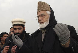APHC chairman Syed Ali Shah Geelani offers prayers along with his supporters at the martyrs graveyard in Srinagar on Monday