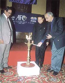 Union Minister of Youth Affairs and Sports Vikram Verma, watched by Asian Football Confederation secretary-general Peter Velappan and All India Football Federation president P R Dasmunshi, lighting a lamp to inaugurate the Vision Asia Football Conference in the Capital