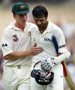 Australian bowler Brett Lee checks on the health of Rahul Dravid after he hit him in the head 