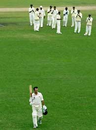 The Indian team applauds Australia's captain Steve Waugh as he walks off the ground after being dismissed for the last time on the final day of the fourth Test at the Sydney Cricket Ground