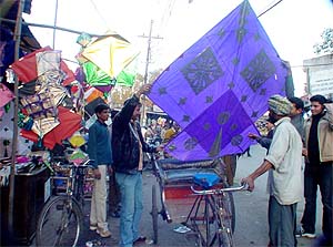 A kite flyer taking home a 9-foot -long kite in Ludhiana