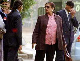 Sri Lankas President Chandrika Kumaratunga goes shopping while surrounded by security officials in Islamabad 