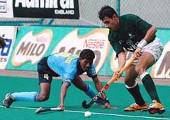 Pakistans Rehan Butt battles for the ball with Indias William Xalco