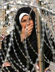 The mother of an Iraqi prisoner waits for news of him outside the US run penitentiary at the Baghdad suburb of Abu Ghraib