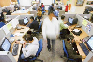 Indian engineers attend to calls from abroad inside a call center in Gurgaon on the outskirts of Indian capital city, New Delhi