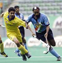 Indias Baljeet Singh Dhillon controls the ball away from Malaysias Logan Raj 
