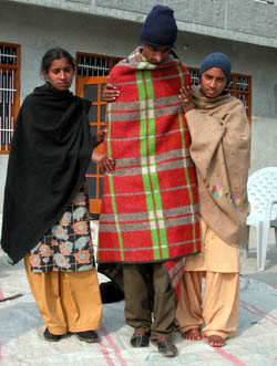 Relatives of Kuldip Singh, whose brother, Hardeep Singh, was found murdered, help him to walk at Chaunta village in Ludhiana district