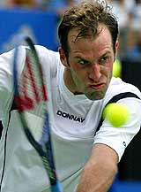 Britain's Greg Rusedski plays a shot against Argentina's Juan Ignacio Chela 