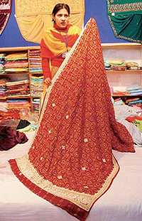 A saleswoman shows the Vivaha line of clothing launched by Amartex.