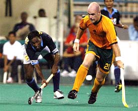 Australias Aaron Hopkins battles for the ball with Indias Vikram Pillay during their match at the Sultan Azlan Shah Cup 