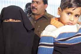 Umar, a 4-year-old who was rescued by the Delhi Police, with his mother Gulshera at a press conference in the Capital