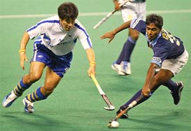 South Korea's Seo Jong Ho and India's Girish Pimpale fight for the ball during the 13th Sultan Azlan Shah Cup Hockey Tournament in Kuala Lumpur 