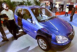 Visitors admire Indigo Marina, a new model, at the 7th Auto-Expo 2004 in New Delhi 