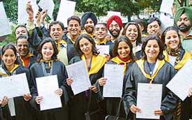 Passouts from a College of Communication and Management, Bharatiya Vidya Bhavan, show their diplomas at the annual convocation function of the college in Chandigarh