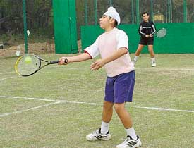 Mandeep Gill and Gauravinder Toor in action in their doubles tie in the sub-junior and junior tennis meet at the Lake Club tennis courts in Chandigarh