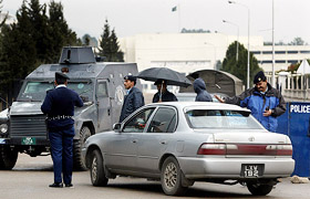 An armoured personal carrier (APC) is parked in front of the Parliament building as security is beefed-up during the first speech of Gen Pervez Musharraf to Parliament in Islamabad on Saturday.
