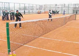 Students of Delhi Public School, Sector 40, practice tennis on their school premises