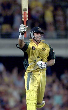 Australia's Matthew Hayden raises the bat after completing his century