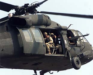 A US Army helicopter flies over the scene of a blast outside the headquarters of the US-led administration 