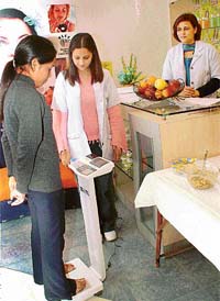 A participant at the slimming carnival being organised by the VLCC, Sector 9, Chandigarh, checks her basal metabolic rate