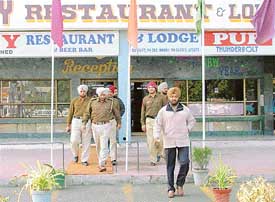 The DSP, Mohali, Harpreet Singh (extreme right), coming out of a lodge in Phase 3B2, Mohali, after searching it for the escapees on Thursday. 