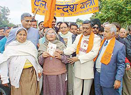 BJP workers, including Mr Satya Pal Jain, a former MP, distribute pamphlets on the governments achievements as a part of Atal Sandesh Yatra in Chandigarh on Friday.