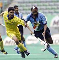 Indias Baljeet Singh Dhillon controls the ball as Malaysias Logan Raj tries to check him during the Sultan Azlan Shah Cup Hockey Tournament in Kuala Lumpur