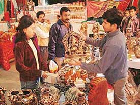 A visitor is shown a Ganesha idol at an exhibition of handicrafts from Madhya Pradesh at Lajpat Rai Bhavan 