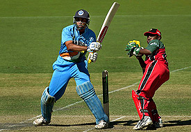 V.V.S. Laxman of India slams a boundary as Tatenda Taibu of Zimbabwe looks on 