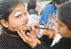 A girl gets guise as a rabbit at a face painting carnival organised by Samsung at Chandigarh Club in Chandigarh