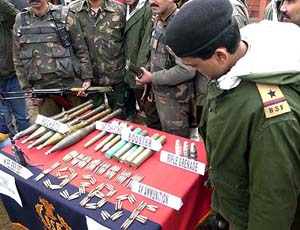 Border Security Force soldiers display ammunitions recovered during a raid in Srinagar