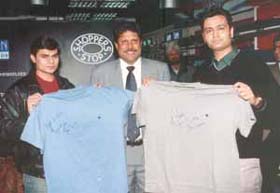 Kapil Dev auctioning T-shirts at a charitable auction of his autographed memorabilia
