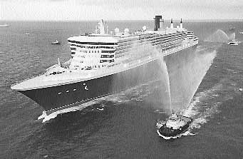 Tugboats welcome the Queen Mary 2, the largest luxury ocean liner ever constructed, as it approaches Port Everglades in Fort Lauderdale, Florida