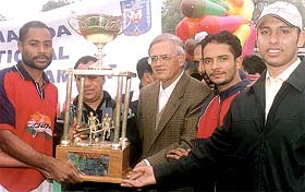 Daljit Singh Dhillon, captain of Punjab Police, receiving the trophy in the All-India DDA Invitational Hockey Tournament from Lt-Governor Vijay Kapoor 