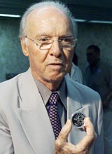 Mario Zagallo, Technical Director of the Brazilian soccer team and the only player to be a part of four World Cup winning Brazilian squad, shows a silver coin issued in Brazil to commemorate the 100th anniversary of FIFA 