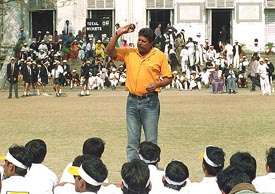 Former cricketer Kapil Dev gives bowling tips to schoolchildren in Kolkata 