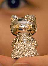 An employee of Tanaka Precious Metals shows a 30-mm-tall, 120-gram platinum statue of Hello Kitty