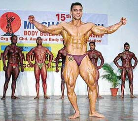 The city-based body builders flex their muscles during the 15th Chandigarh Body Building Championship organised at DAV College auditorium, Sector 10, Chandigarh