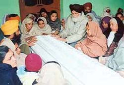 Ikwinders parents with her coffin in Kalsan village near Raikot on Saturday