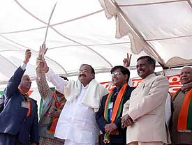 Mr Venkaiah Naidu, national President of the BJP, raises the sword presented to him by the BJP Yuva Morcha in Sector 34