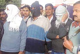 SHAMEFACED: Three wanted kidnappers at the Delhi Police headquarters in the Capital on Sunday.