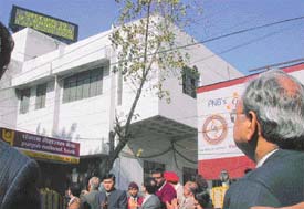 Punjab National Bank General Manager U.S. Bhargava looks at the electromagnetic display board installed by the bank at its Millerganj branch