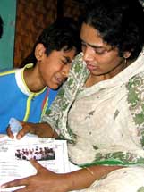 Farida Yasmin, 27, mourns the loss of her father with her cousin Aamir Ali 