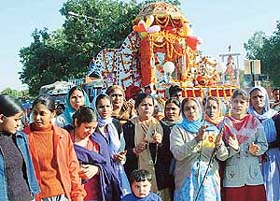 Devotees organise a procession on the eve of the birth anniversary of Guru Ravi Dass in Chandigarh